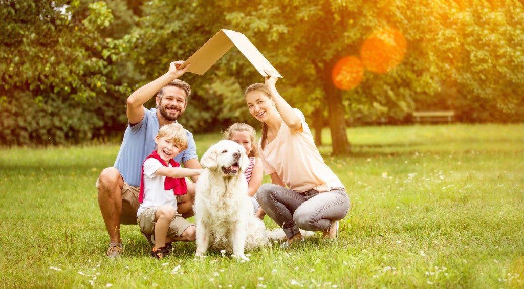 Happy family in their backyard with dog