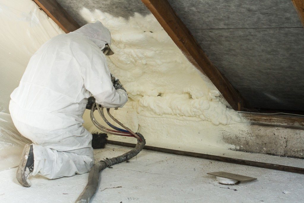 contractor installing insulation in the attic