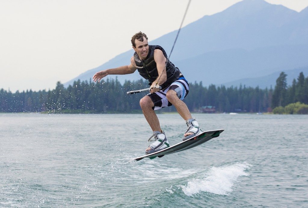 Man wakeboarding on a beautiful mountain lake