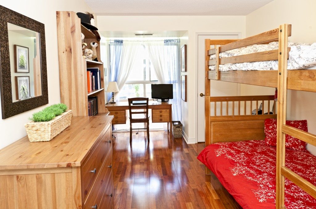 Student bedroom with hardwood floor and bunk beds
