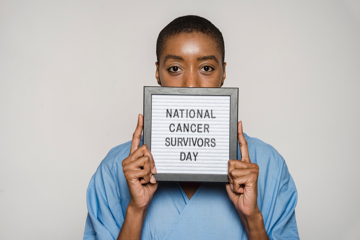 woman holding up national cancer survivors day