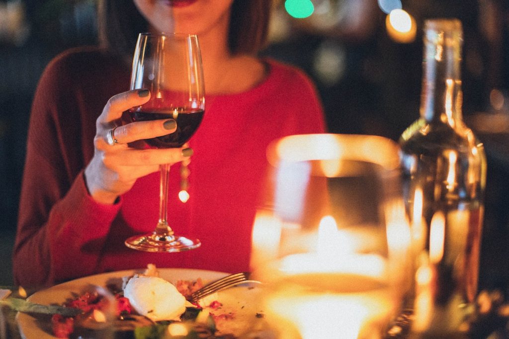 candle light dinner with a woman holding wine glass